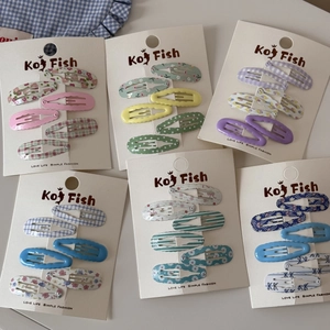 Flat lay of colorful floral and plaid BB hair clips on display cards for girls