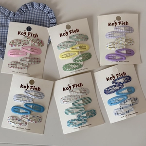 Flat lay of colorful wave and floral print BB hair clips in six vibrant sets