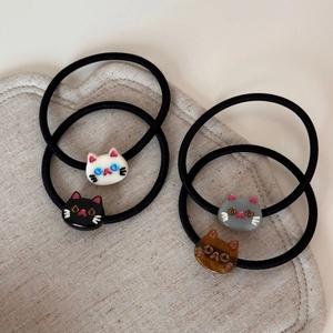 Set of four cute acrylic cat hair ties in white, black, gray, and tortoiseshell