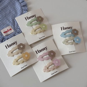 Close-up of colorful floral hair clips and wave patterns on display cards