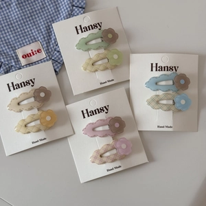 Cute macaron floral hair clip set with pastel flower designs on stylish wave-edged cards