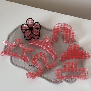 Set of seven red gingham hair claws in various shapes like star and flower patterns