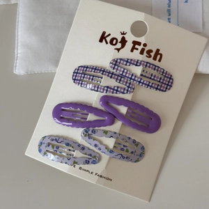 Detail of 6-piece purple hair clip set with wavy checkered patterns and floral prints
