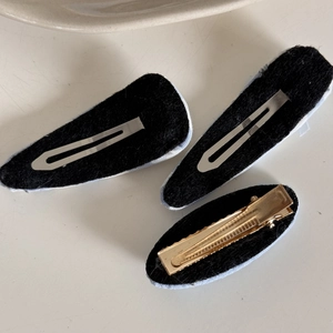 Detailed back view of fabric hair clips showing black non-slip lining and metal fasteners