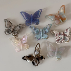 Macro shot of colorful acetate butterfly hair clips set with various marble textures