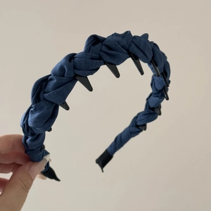 Close-up of dark blue denim braided headband featuring black non-slip inner teeth detail