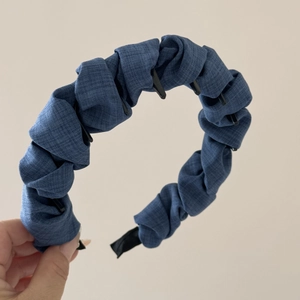 Detail of blue denim headband with inner gripping teeth for non-slip hair styling