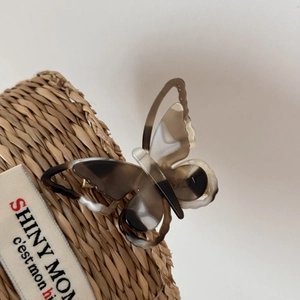 Detail of tortoiseshell acetate butterfly hair clip with double-layer cutout design