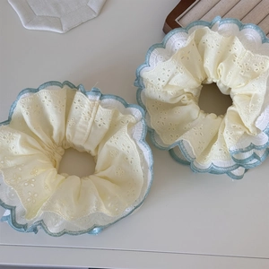 Set of two yellow eyelet embroidery lace hair scrunchies with blue wavy scalloped edges