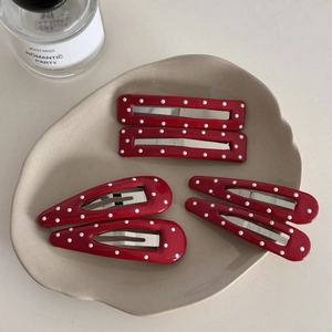 Red leather hair clips with white polka dots set in rectangular and teardrop shapes