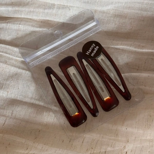 Set of four tortoise shell hair clips in triangle and drop shapes with a matte finish