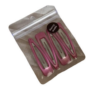Set of 4 elegant pink pearl finish triangular metal BB hair clips in transparent packaging