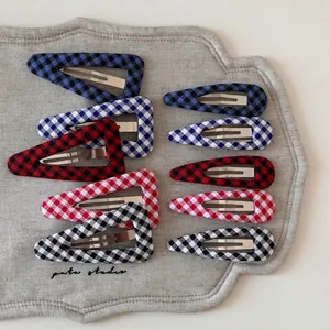 Set of 10 plaid geometric BB hair clips in blue, red, and black checkered patterns
