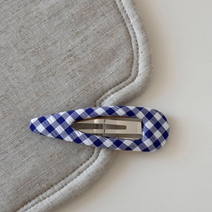 Detail view of blue and white plaid fabric BB hair clip with drop-shaped metal frame