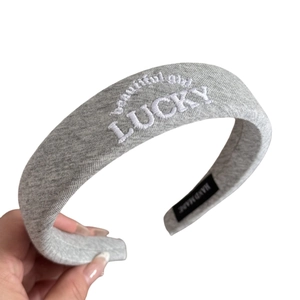 Grey knit padded headband with LUCKY embroidery for high crown hair styling