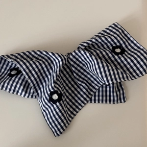 Blue gingham fabric scrunchie with floral embroidery for elegant women's hair styling