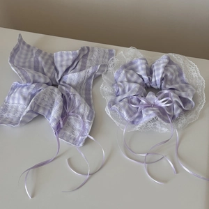 Detail of purple plaid hair scrunchie and bow with delicate lace and silk ribbons