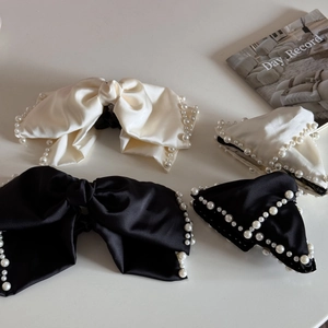 Set of satin bow hair clips with white pearls in classic cream and black colors