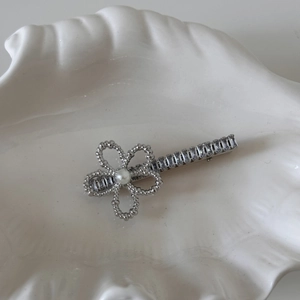 Detail of silver floral hair clip with white pearl and sparkling zircon crystals