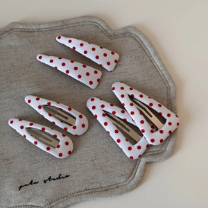 Detailed set of six red polka dot fabric hair clips in BB and triangle shapes