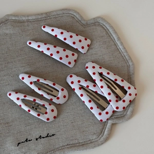 Detail of red polka dot hair clip set including triangular and rectangular fabric styles