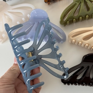 Close-up of butterfly hollow hair claw clips in various colors with metallic springs