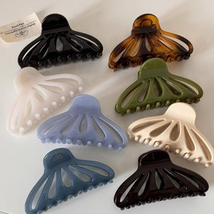 Set of 8 glossy fan-shaped cutout hair claws in various colors for elegant styling
