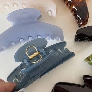 Detailed view of large glossy hair claw clips in various elegant Morandi colors