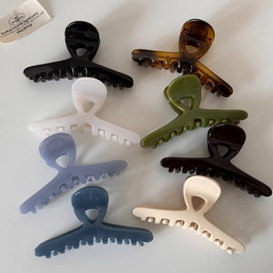 Detailed set of seven glossy cross hair claws in assorted colors on a neutral background