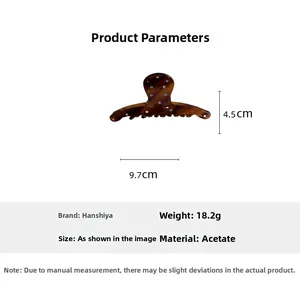 Detail view of tortoiseshell acetate hair clip with dimensions 9.7cm x 4.5cm and 18.2g weight