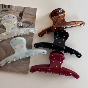 Colorful rhinestone acetate hair claws in diverse shades like amber, blue and berry red