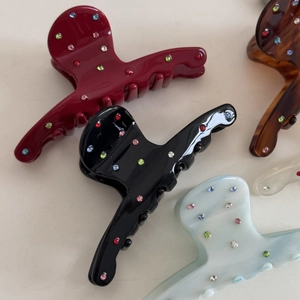 Assorted colorful rhinestone embellished acetate hair claws in various elegant finishes