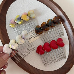 Elegant heart-shaped acetate hair combs in marble and tortoiseshell patterns