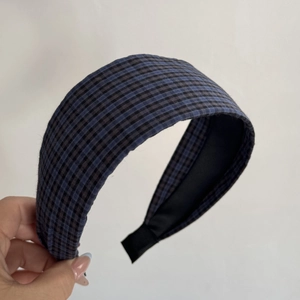 Detail shot of blue and black gingham padded headband with soft inner fabric lining
