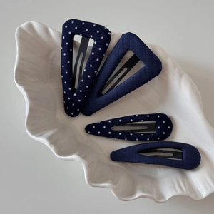Set of navy blue polka dot and solid fabric hair clips in triangle and drop shapes