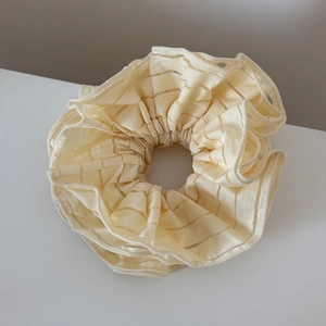 Close-up of cream oversized striped scrunchie with soft cotton-linen texture detail