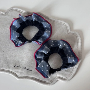 Navy blue polka dot mesh hair scrunchies with red piping and adjustable toggle strap