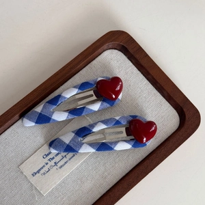Close-up of blue and white checkered fabric BB hair clips with red heart details