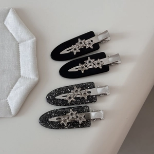 Star hair clips set with sparkling rhinestones on black acetate hair pins for women