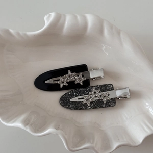 Sparkling star acetate hair clips with rhinestones in black and glitter finish