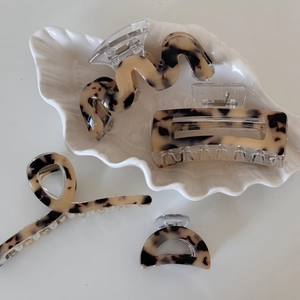 Set of four tortoiseshell acetate hair claws with wave, hollow, and geometric designs