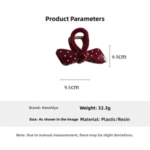 Detail showing dimensions 9.5cm x 6.5cm of the dark red polka dot shark hair claw