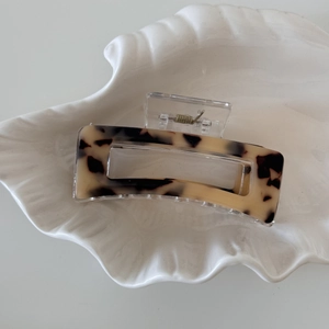 Detailed top view of a rectangular tortoise shell hair claw with cut-out design