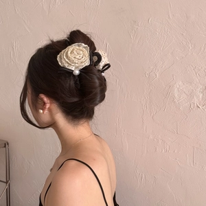 Elegant off-white rose hair claw with lace petals, pearls and a black ribbon bow