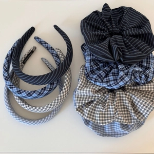 Close-up of handmade sea salt blue scrunchies and headbands set with plaid cotton texture