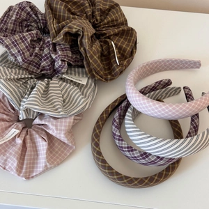 Detail view of plaid scrunchies and lace hairbands set in elegant sea salt blue and brown