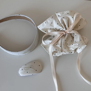Detail view of polka dot hair accessories set including headband, pouch, and clip