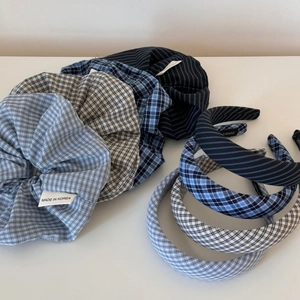 Close-up of blue plaid scrunchies and handmade checkered headband accessories