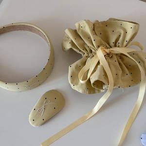 Detailed embroidery of white bows on yellow polka dot fabric hair accessory set
