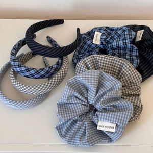 Detailed macro view of sea salt blue plaid and striped cotton fabric scrunchies and headbands